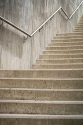 Close up of concrete staircase with metal hand rail