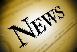 A close-up of a newspaper with the word News emphasized in black on a brown/gold background.