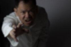 gaussian blurr image of asian male showing frustration 