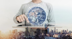Double exposure, a man working on digital tablet and global network connection hologram technology. Element of this image are furnished by NASA