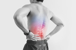 Lower back pain. Shirtless man touching his back with red highlight, on white background