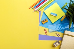 Back to school concept. Colorful stationary school supplies on yellow  background, space or text flat lay