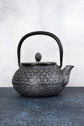 Blue traditional Asian iron teapot. Vertical orientation.