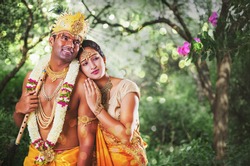 Serious Indian God Krishna and Radha standing together in the forest