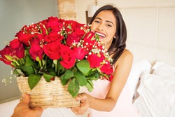happy indian woman getting flowers delivery