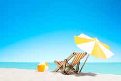 Lounge chair with parasol and beach ball on the coast, sky with copy space