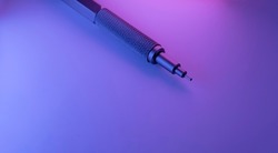 Metal versatile pen illuminated with vibrant lights.