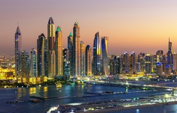 Aerial view on Dubai Marina with skyline - luxury and famous Jumeirah beach frontline at sunrise, United Arab Emirates