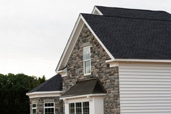 edge of roof shingles on top of the house dark asphalt tiles on the roof background color