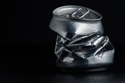 Closeup photo of an aluminum can over a black background. Concept photo to represent recycling, waste, metal, etc.