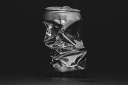 Closeup photo of an aluminum can over a black background. Concept photo to represent recycling, waste, metal, etc.