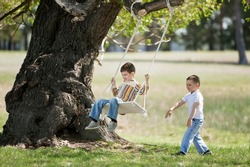 Children on a swing on a nature