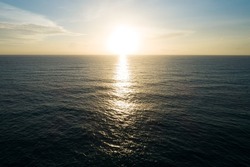 Aerial view Beautiful view sunset over sea surface beautiful small wave in the ocean Amazing light sunset or sunrise sky over sea evening sky Dark sea