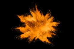 Orange powder explosion on black  background. Colored cloud. Colorful dust explode. Paint Holi.