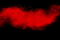 Red powder explosion on black background.