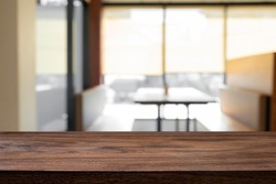 Empty wooden table with blur background of office and meeting room.