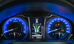 Modern car instrument panel dashboard with blue illuminated display.