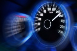 Motion blur of modern car instrument panel dashboard with blue illuminated display, rev up.