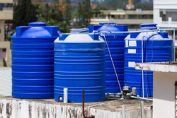 Blue water tanks of industrial building on roof top or deck in Phuket