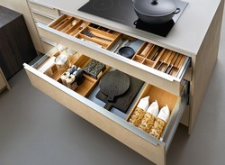 Modern kitchen, Open drawers, Set of cutlery trays in kitchen drawer. Solid oak wood cutlery drawer inserts.