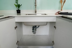 Open cabinet under sink 1 bowls with installed water pipe, water filter , Accessories aluminum under cabinet sink protection .White kitchen cabinet.