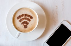 WiFi symbol made of cinnamon as coffee decoration of cappuccino. 