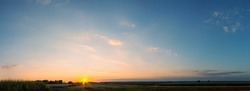
panoramic sunset view over fields in summer