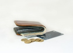 Coin, Dollar bills and credit card on brown wallet isolate on white background. 