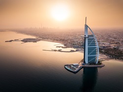 Dubai seaside skyline with luxury hotel aerial view at sunrise
