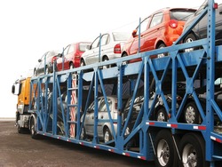 Brand-new cars on a car transport truck at Rosario city, Argentina, near the factory