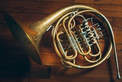 Golden french horn with Wooden Background