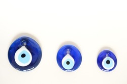Blue bead worn against the evil eye with white background. Blue bead concept. Evil eye bead concept background. Selective focus.