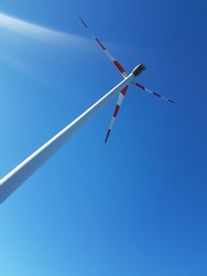 a wind turbine photographed from below 