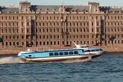 The pleasure boat floats on the river at a speed. European city tour by water.