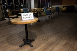There is a sign on a small table that 