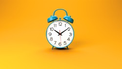 blue retro alarm clock on orange background
