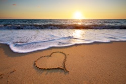 Heart on beach. Romantic composition.