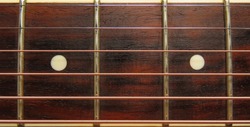 Dark Wooden guitar fretboard background