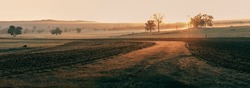 images of a misty foggy soft golden sunrise overlooking ploughed fields and farmland in Western Australia