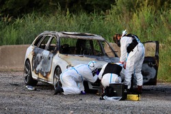 Swedish forensic scientists investigate the burned-out car that is believed to be connected to a shooting in which a 12-year-old girl died.