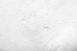 Fluffy white foam texture with small bubbles.