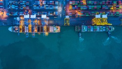 Container ship loading and unloading in deep sea port, Aerial view business commercial trading logistic import and export freight transportation, Container loading cargo freight ship maritime at night