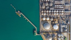 Aerial view of tank farm oil and gas terminal with lots of fuel petroleum chemical natural gas storage tank and petrochemical in the harbour, Business power and energy industrial tank storage .