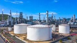 Oil​ refinery​ and​ petrochemical​ architecture plant industrial with blue sky background, White oil and gas refinery tank, Oil refinery plant from industry zone business power and energy petroleum.