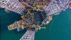 Aerial view maintenance repair of the jack up oil and gas rig up in the shipyard, Offshore oil and Gas processing platform, oil and gas industry.