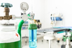 Medical oxygen flow meter shows low oxygen with patient bed in hospital, Equipment medical Oxygen tank and Cylinder for care a patient respiratory disease and emergency CPR at Hospital.