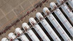 Aerial view natural white gas tank and pipeline, Tank storage chemical petroleum petrochemical refinery product at oil and gas storage terminal company.