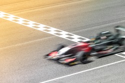 Motion blur, Race car racing on race track with start and finish line.