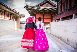 Korean Girls dressed Hanbok in traditional culture dress of South Korea walking in beautiful ancient castle architecture Gyeongbokgung Palace, People travel in Asia concept, Seoul City, South Korea.