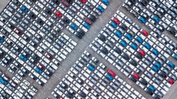 Aerial view new car lined up in the port for import and export business logistic to dealership for sale, Automobile and automotive car parking lot for commercial business  industry.